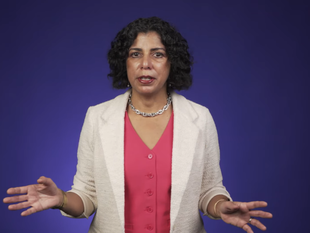 Raissa D’Souza speaking with a purple background