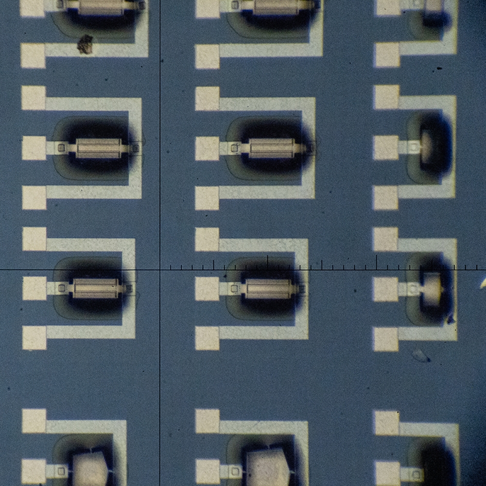 Microscopic view of nanoscale detecors, which look like black and white lines and squares in a geometric pattern on a blue background