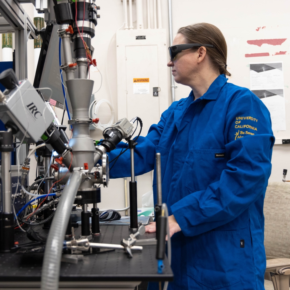 Nicole O'Shea handling lab machinery