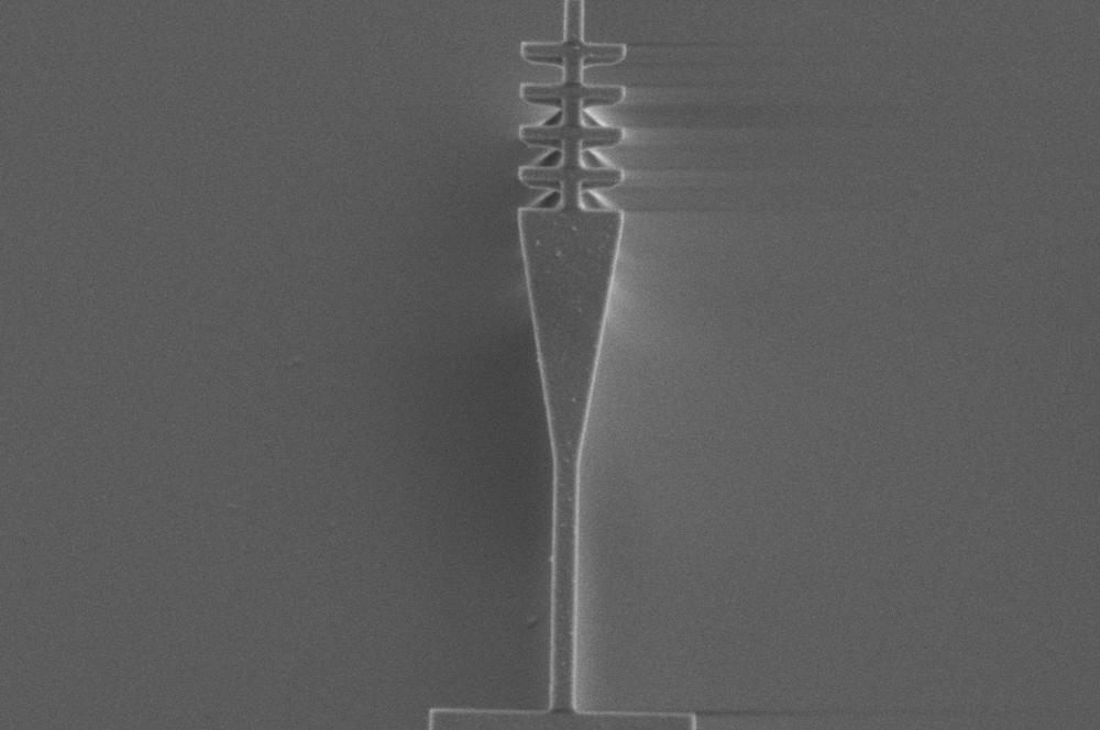 A long, thin shape with triangular prisms at one end