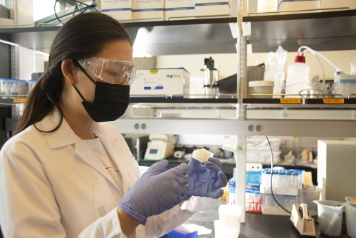 Student in lab holding a jelly ice cube