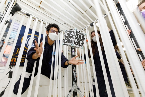 Researcher releasing a floating CubeSat