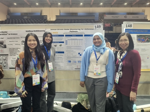 Students pose with their research poster