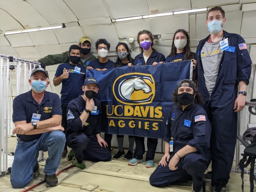 All students posing with UC Davis flag