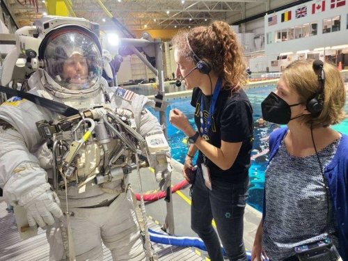 Janine communicating with person in a space suit