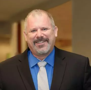 Headshot of Jeff in a suit