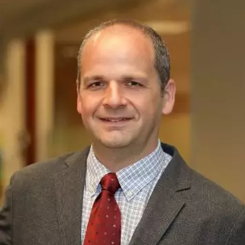 Headshot of Pedro in a suit