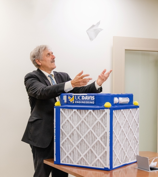 UC Davis College of Engineering Dean Richard Corsi lets the air of a Corsi-Rosenthal Box float a tissue