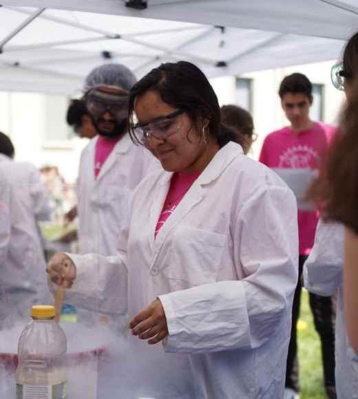 UC Davis engineering student Ana Reyes Ochoa in lab coat at outdoor event