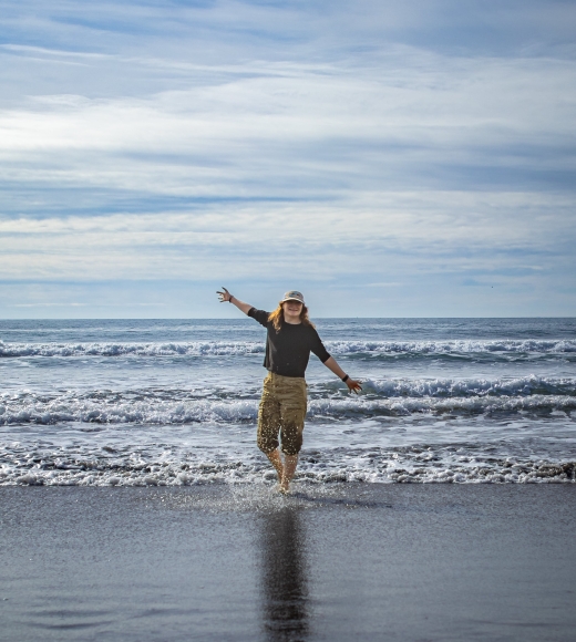 Humphries standing in shallow beach waves