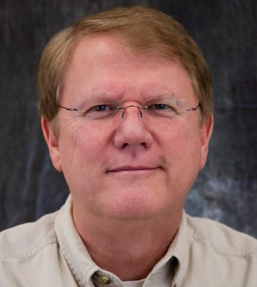 A headshot of Roger Davis