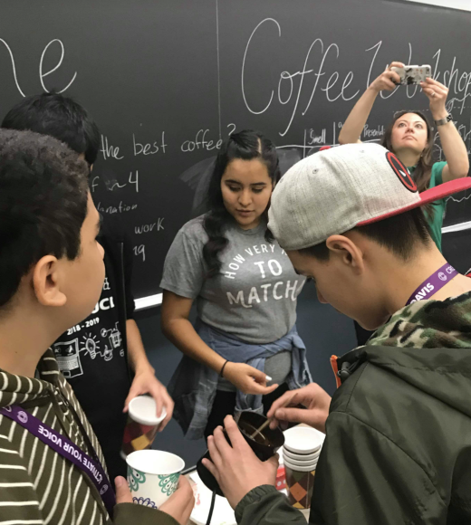 Group of people at a club event in front of a chalkboard