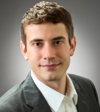 A portrait of a man wearing a suit against