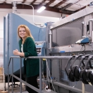 Christina Harvey with machinery in background
