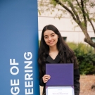 Sabrina NoorAhmad-Yarzada holds award near College of Engineering banner