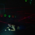 A woman crawling under a laser beam