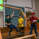 Three people displaying a harness swing