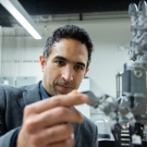 Iman Soltani holds something in lab