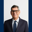 Francisco Parisi in a dark suit and glasses