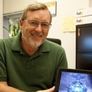 Kenneth Joy holding a tablet