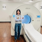 Xiaoyu Duan stands before a uEXPLORER total-body PET scanner