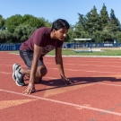 Saha crouched on a track to begin running