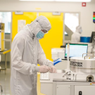 Person in CNM2 wears PPE and operates lab equipment