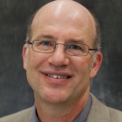 A headshot of Greg Miller