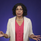 Raissa D’Souza speaking with a purple background