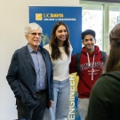 Jerry Baldwin stands with students in front of a College of Engineering banner