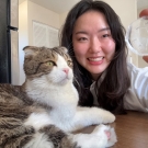 A woman poses with her cat