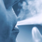Someone blowing smoke out of their mouth