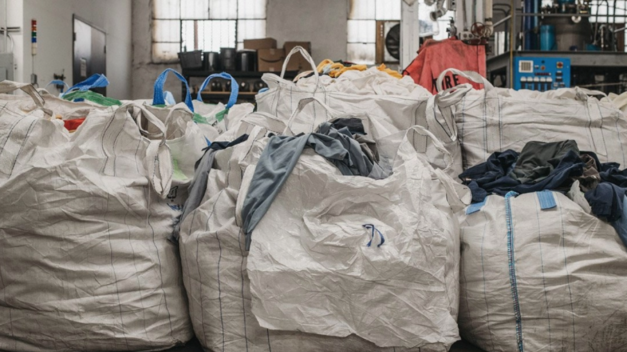 Piles of clothes in large bags